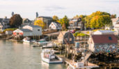 view-of-kittery-maine. there-is-a-large-body-of-water-in-the-foreground-with-boats-docked-in-the-port.
